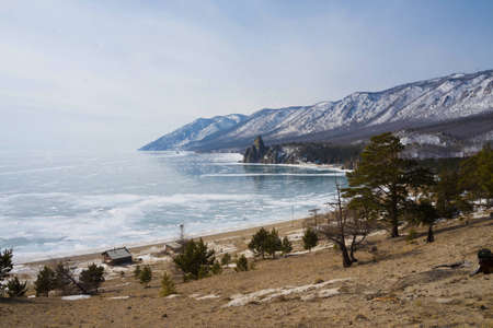 view of the frozen lake, mountains and treesの写真素材