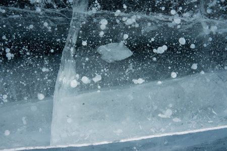 bubbles in blue transparent ice on the lake
