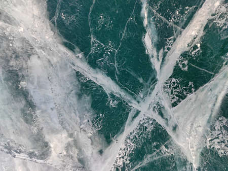 lake with transparent ice and cracks