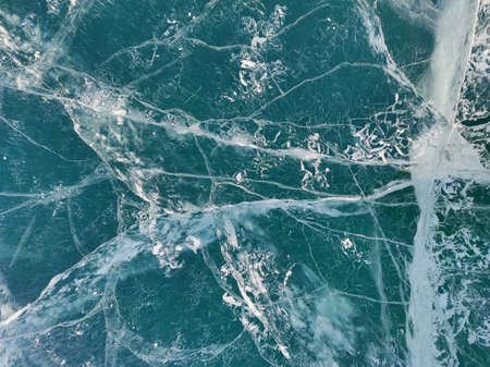 lake with transparent ice and cracksの写真素材