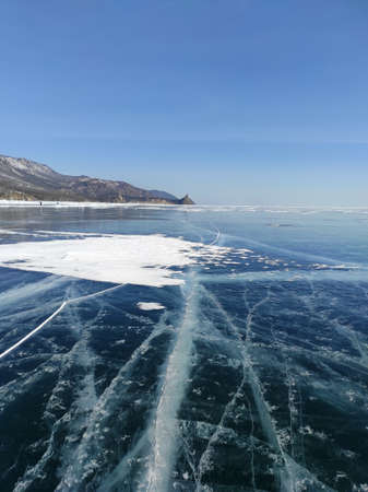 lake with transparent ice and cracksの写真素材