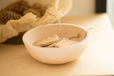a clay plate is on a wooden shelfの写真素材