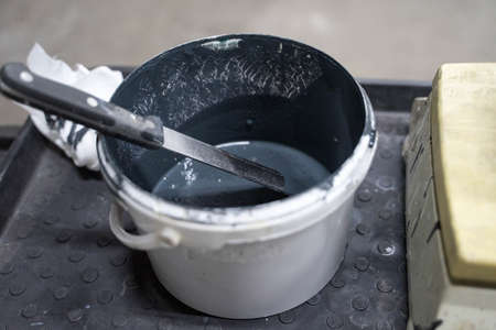 white plastic jar with dark paintの写真素材