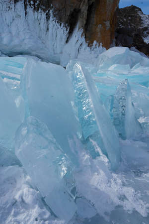 rocks with ice overlaps and icicles near the lake