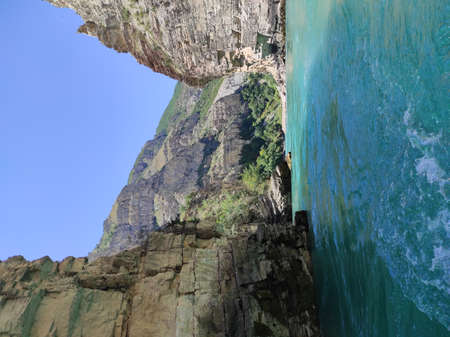 deep canyon with a blue river and beautiful mountains against the skyの写真素材