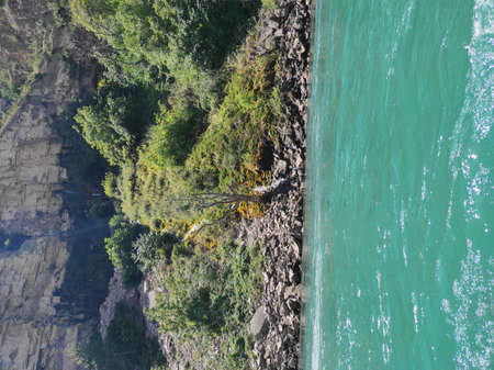deep canyon with a blue river and beautiful mountains against the skyの写真素材