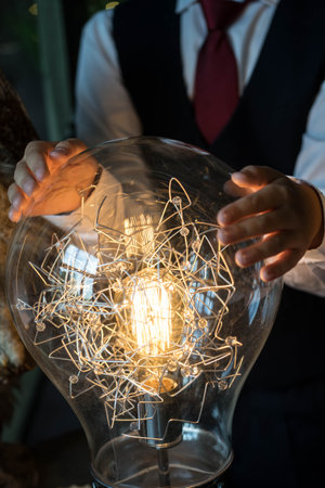 boy holding his hands over the lamp