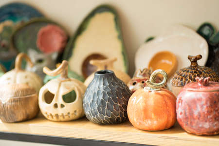 clay products are on a wooden shelf