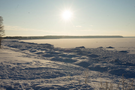 frosty, sunny day on a frozen lakeの写真素材