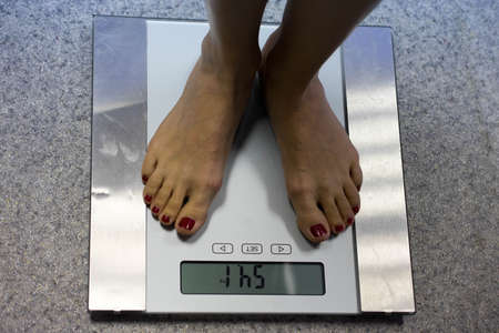 girl standing on the scales
