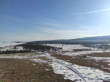 ground with snow against the blue sky