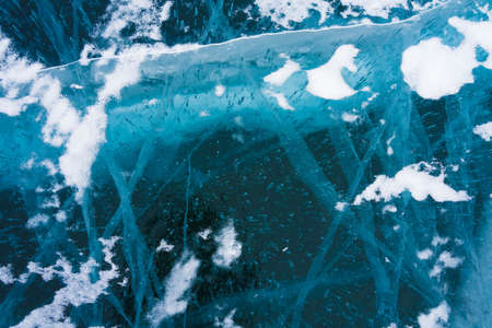 cracks in the transparent ice of Lake Baikal in winter