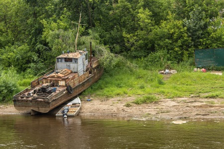 KIROV,RUSSIA-JULE 26, 2017: rusty old motor ship on the bank of the river Vyatkaのeditorial素材