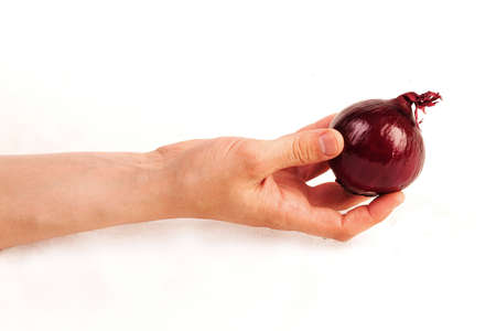 Hand holding and giving violet onionの写真素材