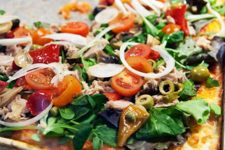 Closeup pf pizza on pan in pizzeria.の写真素材