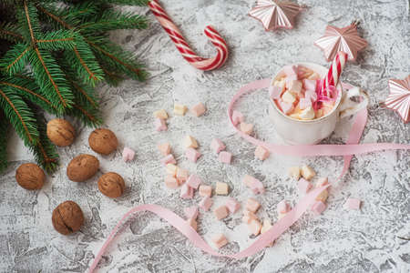 New Years or Christmas composition cup with marshmelow with candy among New Years, shiny toys,...