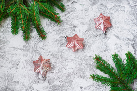 New Year's or Christmas composition of spruce green branches and New Year's toys on a bright...