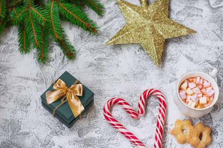 New Year's or Christmas composition of spruce green branches, New Year's star, gift cup with...