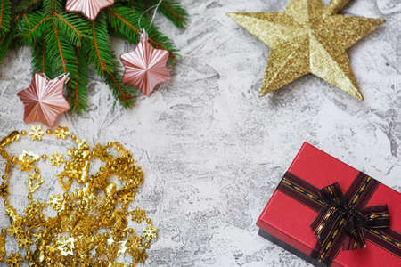 New Years or Christmas composition of spruce green branches, New Years garland, gift, star and...