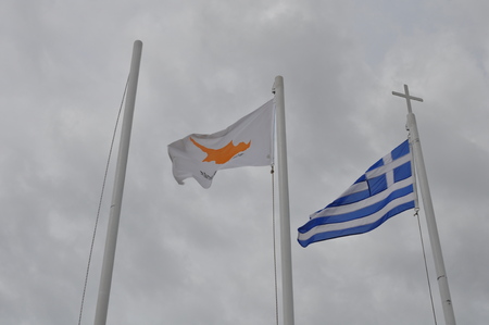 Greece and Cyprus flag on flagpoleの写真素材