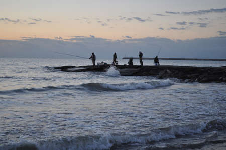 The fisherman at sunrise on the seaの写真素材