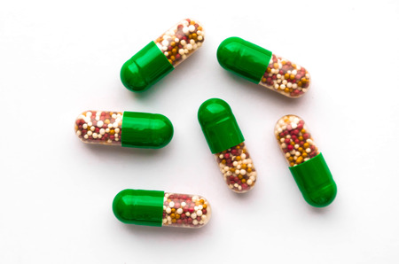 Green pills on a white backgroundの写真素材