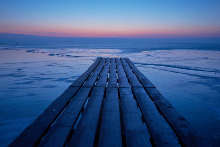 wooden pontoon with boats before sunrise in the Danube delta 01の写真素材