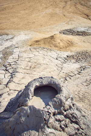 cones of mud volcanoes from which rivers of mud flowの写真素材