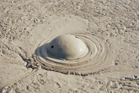 cones of mud volcanoes from which rivers of mud flowの写真素材