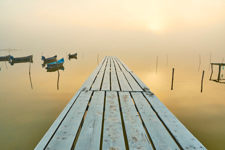 fishing boats on the lake in the fogの写真素材