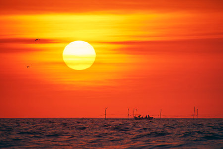 sunrise with a fishing boat on the Black Seaの写真素材