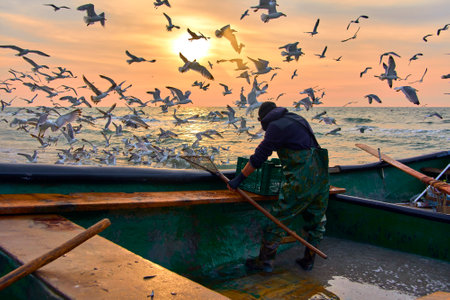 sunrise with a fishing boat on the Black Seaの写真素材