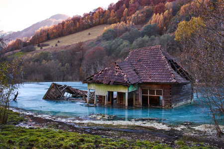 house engulfed by waste dumps in the village of Geamanaの写真素材