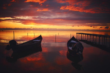 boat at sunrise on the lakeの写真素材