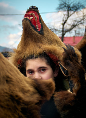 People dancing dressed in bearskin and folk costumes at the Comanesti Customs and Traditions Festival on December 30, 2025のeditorial素材