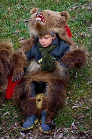People dancing dressed in bearskin and folk costumes at the Comanesti Customs and Traditions Festival on December 30, 2025のeditorial素材