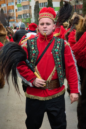 People dancing dressed in bearskin and folk costumes at the Comanesti Customs and Traditions Festival on December 30, 2025のeditorial素材