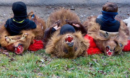 People dancing dressed in bearskin and folk costumes at the Comanesti Customs and Traditions Festival on December 30, 2025のeditorial素材