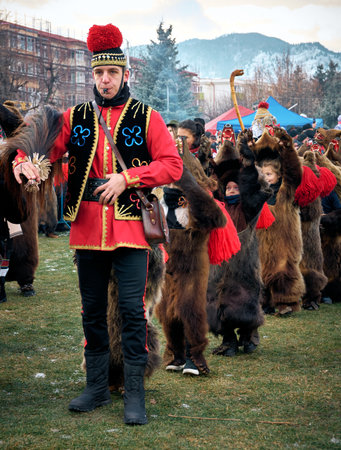 People dancing dressed in bearskin and folk costumes at the Comanesti Customs and Traditions Festival on December 30, 2025のeditorial素材