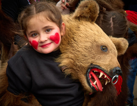 People dancing dressed in bearskin and folk costumes at the Comanesti Customs and Traditions Festival on December 30, 2025のeditorial素材