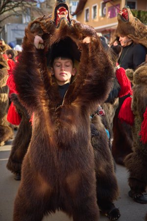 People dancing dressed in bearskin and folk costumes at the Comanesti Customs and Traditions Festival on December 30, 2025のeditorial素材