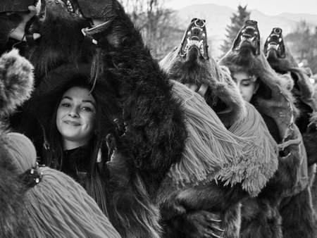 People dancing dressed in bearskin and folk costumes at the Comanesti Customs and Traditions Festival on December 30, 2025のeditorial素材