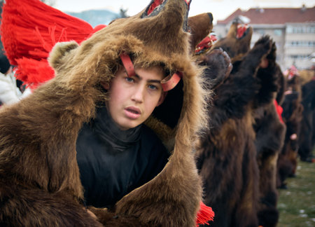 People dancing dressed in bearskin and folk costumes at the Comanesti Customs and Traditions...