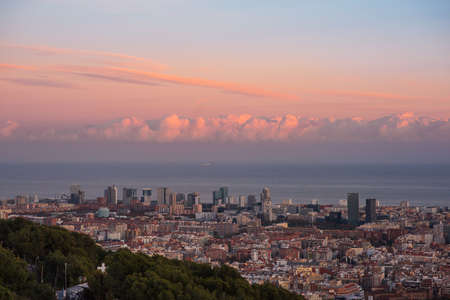 Aerial view of the city of Barcelona at sunset with blue sky and white cloudsのeditorial素材