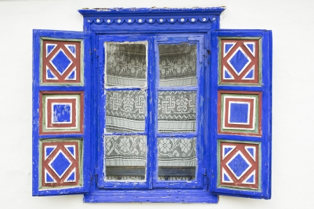 A window of a traditional peasant house with shuttersの写真素材