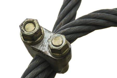 Twisted heavy duty steel cable fixed with an anchor isolated on white backgroundの写真素材