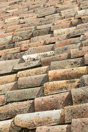 Brick shingles roof covered with moss and lichens, backgroundの写真素材