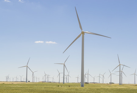 Numerous wind turbine network , spread over a wide area harvesting wind power and transforming it into electricityの写真素材