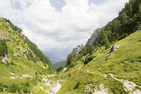 Mountain valley landscape with steep slopes , cliffs and precipicesの写真素材