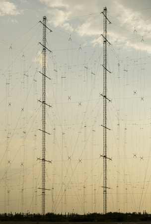 High antenna poles sustaining complex radio communication grid ,at sunsetの写真素材